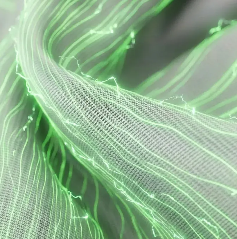 Close-up of grey textured sportswear fabric woven with glowing green energy lines and electrical currents.