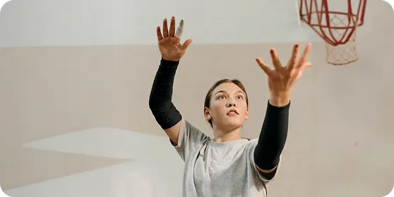 Basketball player wearing black athletic arm sleeves by Ion Sportswear