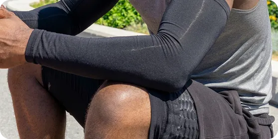Athlete wearing black UV protection arm sleeves by Ion Sportswear