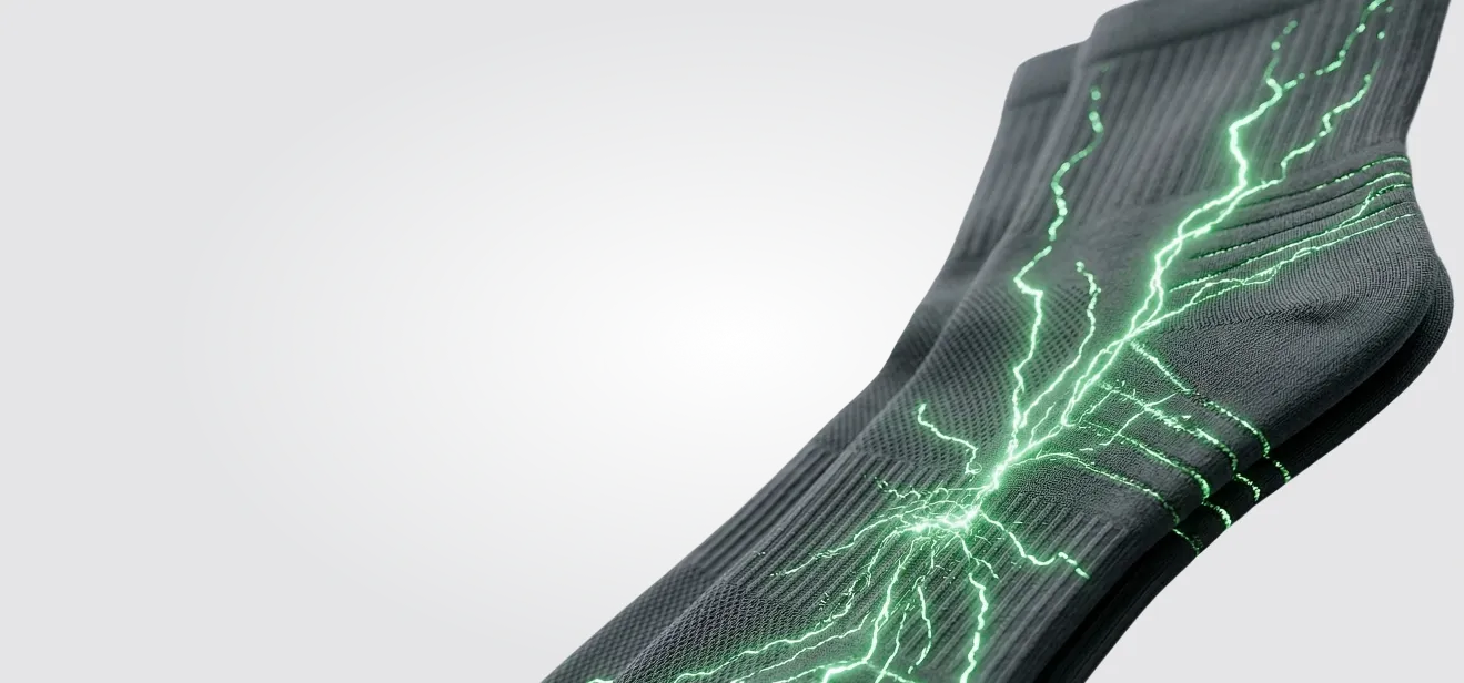 Ion Sportswear dark compression socks with a glowing green energy current.